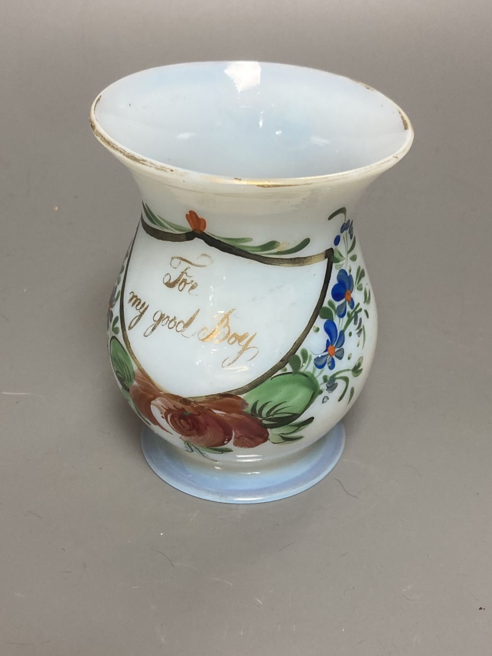 A Bohemian amber flash cut beaker vase, a pair of amber wine glass coolers, 10cm high and a floral painted opaque glass beaker vase, in